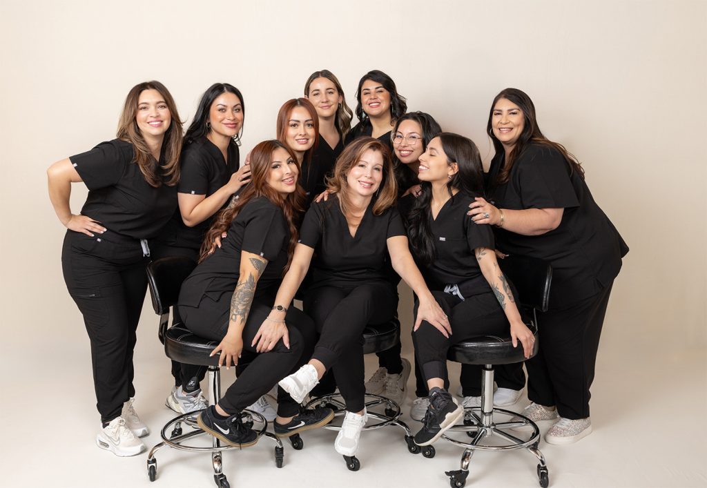 Diverse team of MedSpa professionals celebrating business growth and team success in a high-performing work culture