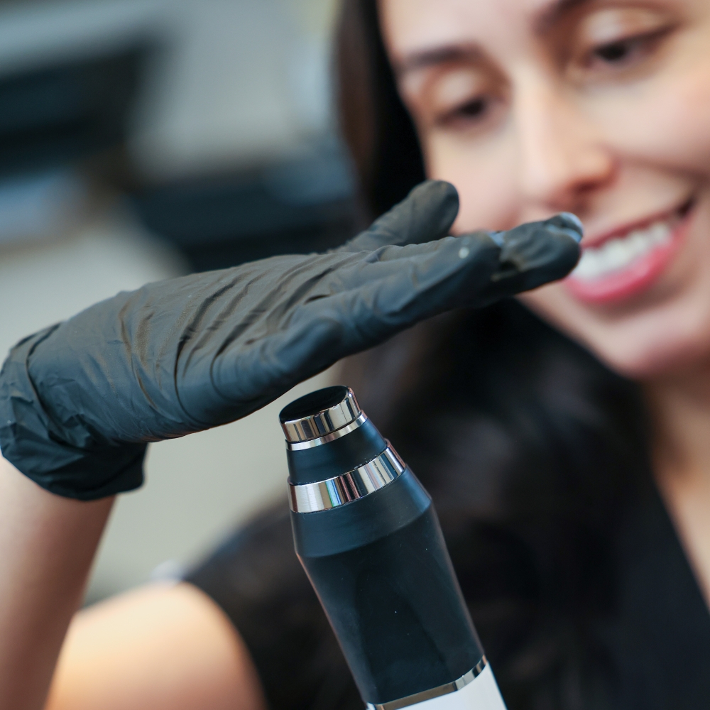 Close-up of MedSpa professional preparing advanced aesthetic treatment device, emphasizing safety and technology in medical aesthetics