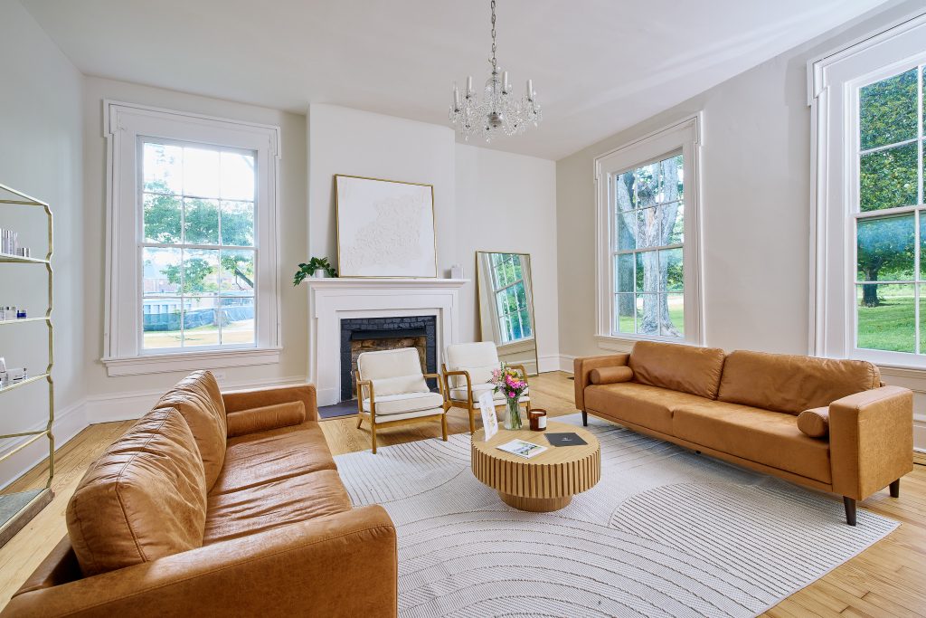 Sophisticated MedSpa waiting room with symmetrical layout, leather sofas, and soft MedSpa decor that promotes relaxation and brand identity.