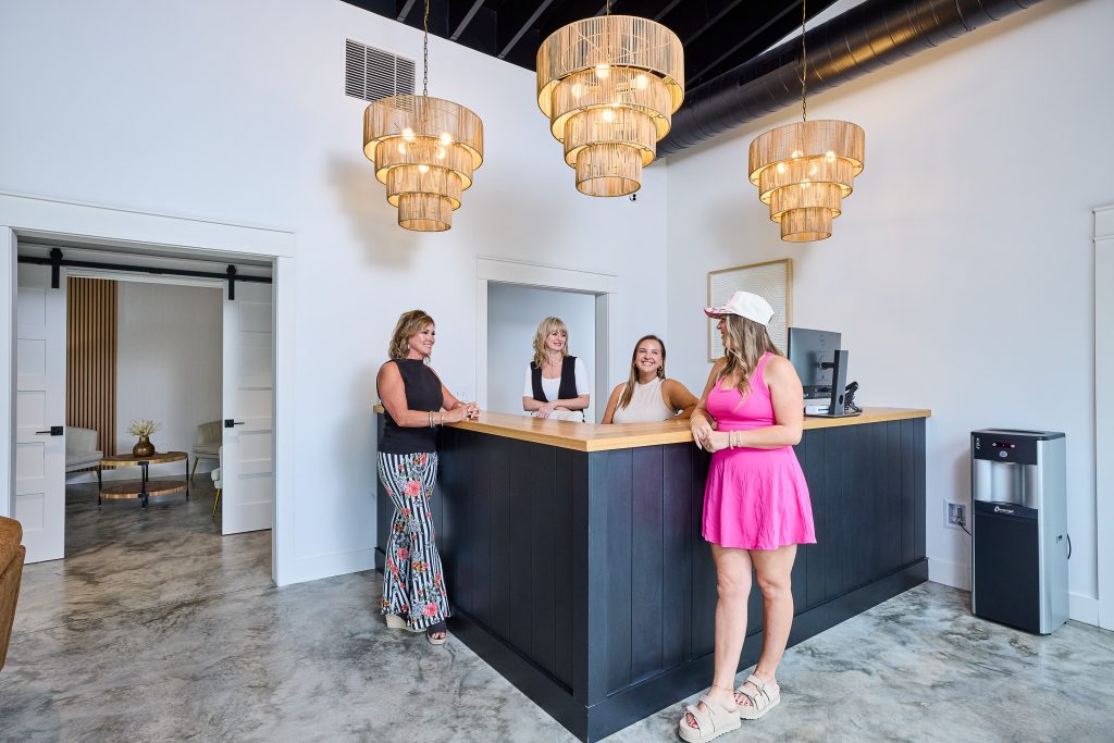 Welcoming MedSpa reception area with luxury pendant lighting, natural textures, and stylish MedSpa decor that balances professionalism and warmth.