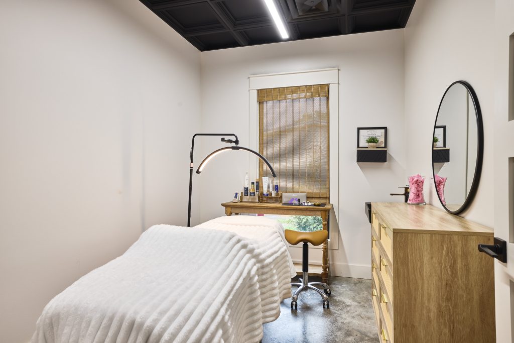 Tranquil MedSpa treatment suite with cozy white bedding, ambient lighting, and calming MedSpa decor focused on comfort and care.
